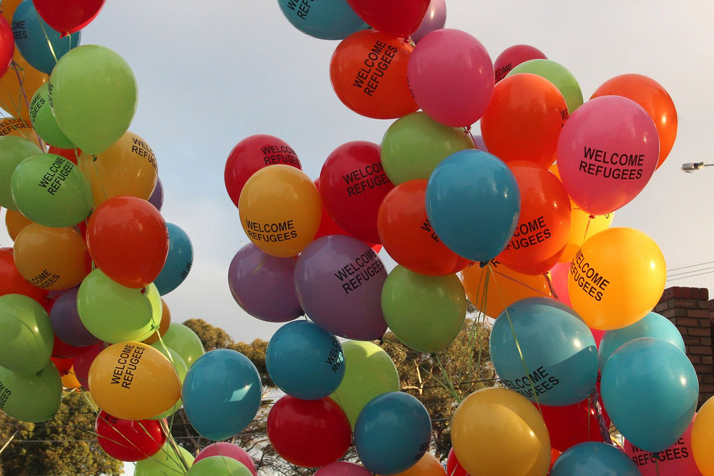 Bild 1: Geflüchtete Willkommen Originaltitel: Welcome refugees balloons – Refugee vigil Broadmeadows  Urheber: Takver Quelle: https://www.flickr.com/photos/takver/6719816855/in/photolist-beNPri-QQDmZx-6EunBB-oZGgzn-aUcXzH-aVHdDH-QXYxjb-9bbTfV-r7zjuy-RJWxEX-9p4fsC-cfHQUC-oipVPq-hTh3UX-maVArP-aFCowe-o4qbDY-JpWMr5-7oroHM-RErXnq-78cxz7-aEZB21-qKTZQd-6GU9sf-cq8yUS-gunVTz-8CHeTP-jxnFXP-pRbTZs-bXLPUb-qMNfBU-RKrMs3-dumZGp-cmCnCY-a9DiNw-R1zQVF-fXjLNc-nHbfAU-S4y37e-RET7Kw-RETcX5-7TU75G-81Ame1-S4y4Nv-S4y1XF-syKk2r-aByDUr-RJ9vC3-BWaSY4-mka6s4 Lizenz: https://creativecommons.org/licenses/by-sa/2.0/